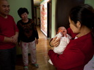 Yu Qiuyan (right) held her newborn baby girl Li Muhua, as father Li Wanhong (left) and a relative stood by in Beijing on January 26. Yu Qiuyan (right) held her newborn baby girl Li Muhua, as father Li Wanhong (left) and a relative stood by in Beijing on January 26.