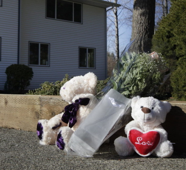 Toys and flowers have been left outside the Puyallup, Wash., home of Chuck and Judy Cox, the grandparents of Charlie and Braden Powell.