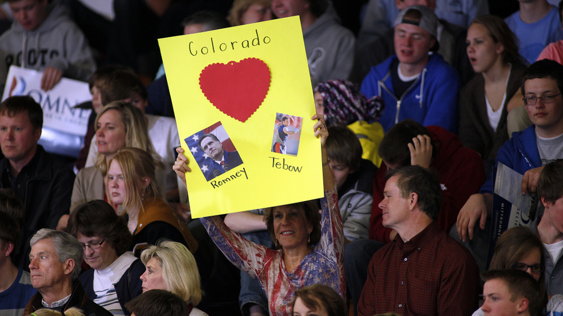 A Mitt Romney supporter holds up a sign showing her love for Romney and Denver Broncos quarterback Tim Tebow at a rally for the GOP presidential candidate at Arapahoe High School this week in Centennial, Colo.