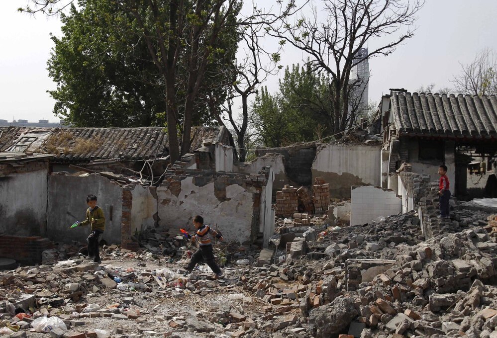 Children play in a traditional residential district in Beijing that is undergoing demolition, in April 2011. Despite public protest, historic and new homes are being destroyed all over the city to make way for development. 