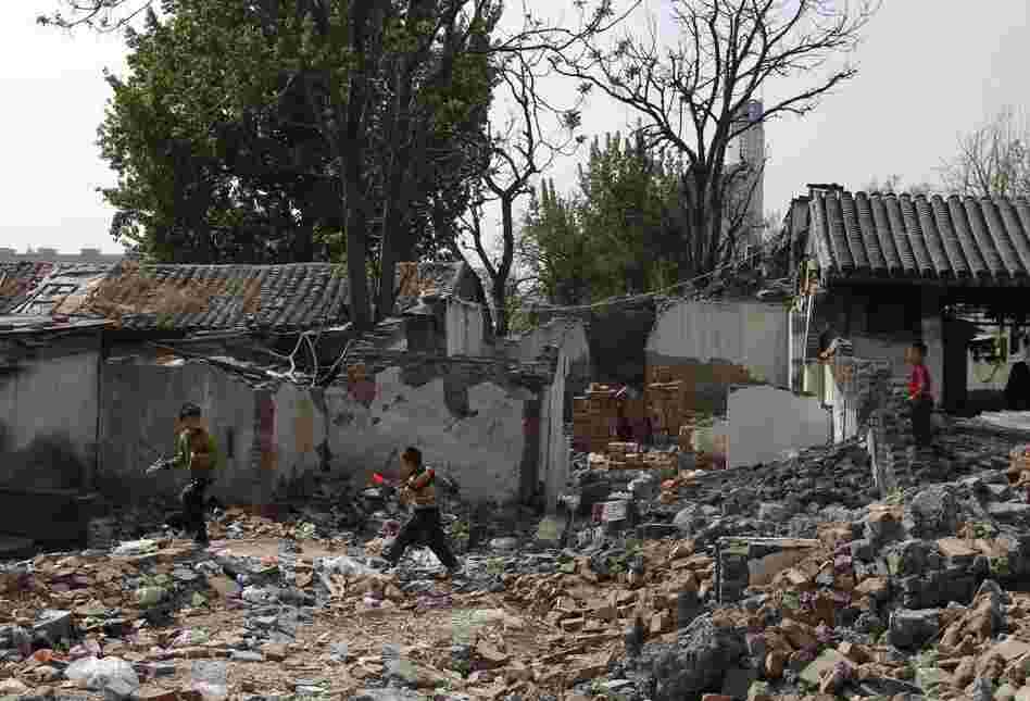 Children play in a traditional residential district in Beijing that is undergoing demolition, in April 2011. Despite public protest, historic and new homes are being destroyed all over the city to make way for development. 