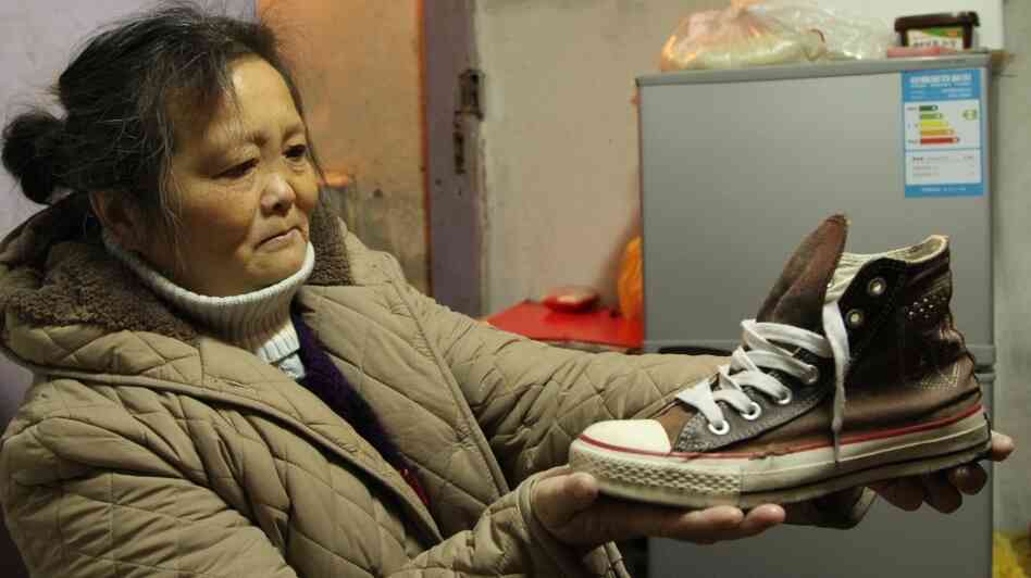 Chuck Taylor All Stars are common on the streets of Shanghai. Xuan Zhihui, 62, a retiree from a state-owned factory, wears her daughter's hand-me-down sneakers, which are 15 years old. She says they're really comfortable. Chuck Taylor All Stars are common on the streets of Shanghai. Xuan Zhihui, 62, a retiree from a state-owned factory, wears her daughter's hand-me-down sneakers, which are 15 years old. She says they're really comfortable.