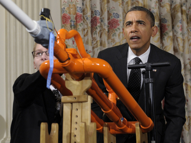President Barack Obama helps launch a marshmallow with a gun designed by Joey Hudy, left, of Phoenix, Ariz., during the White House Science Fair.