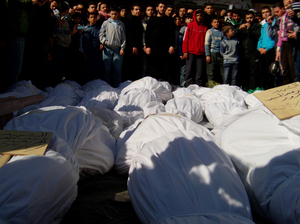 Residents attend a burial ceremony of what activists say are victims of shelling by the Syrian army in the Khalidiya neighborhood in Homs on Feb. 4. Residents attend a burial ceremony of what activists say are victims of shelling by the Syrian army in the Khalidiya neighborhood in Homs on Feb. 4.
