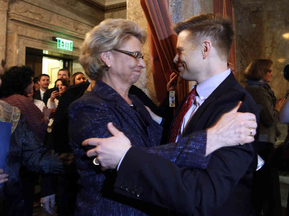 Gov. Chris Gregoire, left, embraces Rep. Jamie Pedersen, D-Seattle, after the Washington state House voted Wednesday to legalize gay marriage.