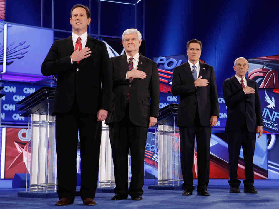 GOP presidential candidates (from left) Rick Santorum, Newt Gingrich, Mitt Romney and Ron Paul place their hands over their hearts during the national anthem at the start of a debate in Florida last month. GOP presidential candidates (from left) Rick Santorum, Newt Gingrich, Mitt Romney and Ron Paul place their hands over their hearts during the national anthem at the start of a debate in Florida last month.