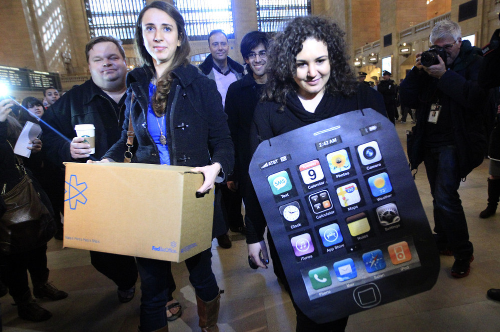 Sarah Ryan, left, and Shelby Knox, with Change.org arrive at the Apple store at Grand Central to deliver petitions asking Apple to change its manufacturing practices.