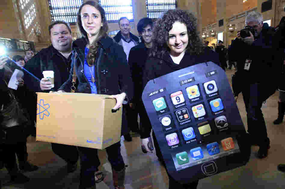 Sarah Ryan, left, and Shelby Knox, with Change.org arrive at the Apple store at Grand Central to deliver petitions asking Apple to change its manufacturing practices.
