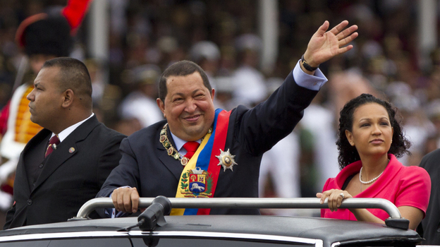 President Hugo Chavez waves during a military parade in Caracas, Venezuela, to commemorate the 20th anniversary of a failed coup attempt he led. After battling cancer last year, Chavez has returned to his high-profile, fiery ways.