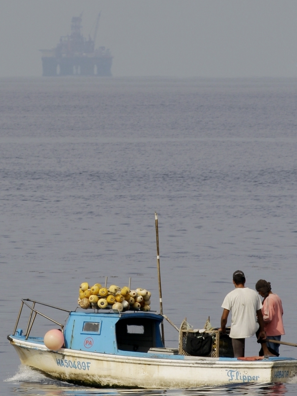 Fishermen work near the Scarabeo-9 oil rig off the coast of Cuba. U.S. officials are concerned about the potential impact in the case of a spill. 