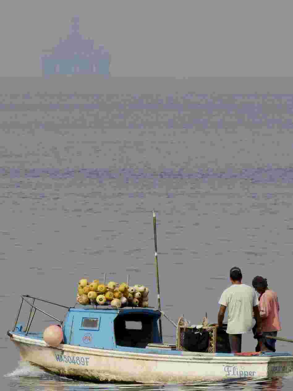 Fishermen work near the Scarabeo-9 oil rig off the coast of Cuba. U.S. officials are concerned about the potential impact in the case of a spill. 