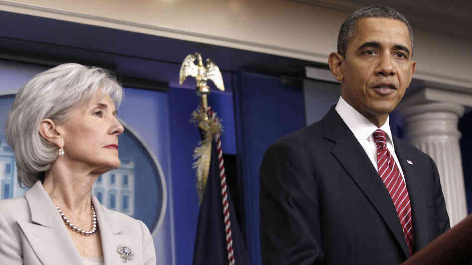 President Obama, flanked by Health and Human Services Secretary Kathleen Sebelius, announces the revamp of the contraception-care policy on Friday.