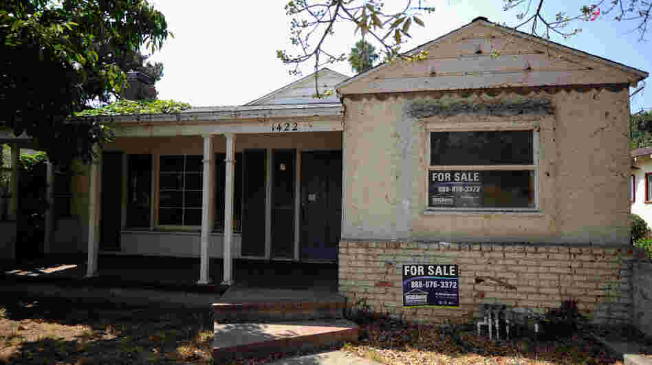 For sale signs on a foreclosed house in Glendale, Calif., last September.