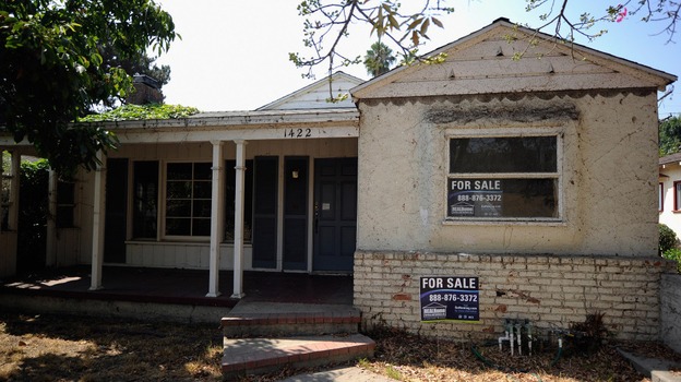 For sale signs on a foreclosed house in Glendale, Calif., last September. (Getty Images)
