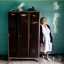 Nurse Stella Trivizaki stands in an abandoned locker room at Asklypeio Public Hospital in Athens, Greece. Nurse Stella Trivizaki stands in an abandoned locker room at Asklypeio Public Hospital in Athens, Greece.