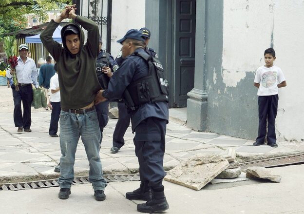 A police officer frisks a man as part of Operation Lightning, an initiative that seeks to stop violence in Honduras, in Tegucigalpa, on Nov. 1. 