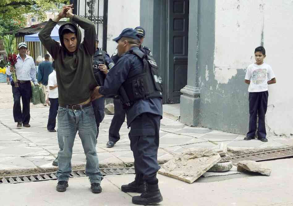 A police officer frisks a man as part of Operation Lightning, an initiative that seeks to stop violence in Honduras, in Tegucigalpa, on Nov. 1. 
