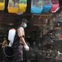 A government veterinarian worker sprays anti-bird flu disinfectant over birds and fowls at Medan city market in North Sumatra province. Indonesia reported its second human death from bird flu this year in late January. 