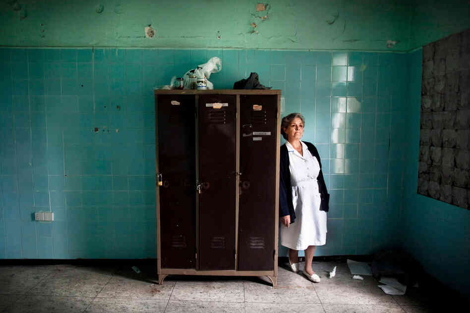 Stella Trivizaki stands near an abandoned locker at Asklypeio Public Hospital in Athens. This nurse's area was scheduled for renovation four years ago.