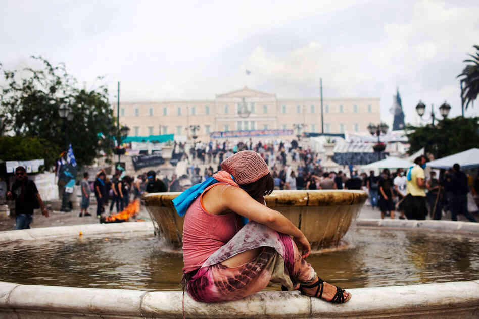 A woman recuperates in Athens' Syntagma Square after being gassed during a demonstration against austerity measures last summer.