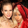 The improbable pair of country star Taylor Swift and rapper Nicki Minaj sitting together at the Staples Center Sunday night.