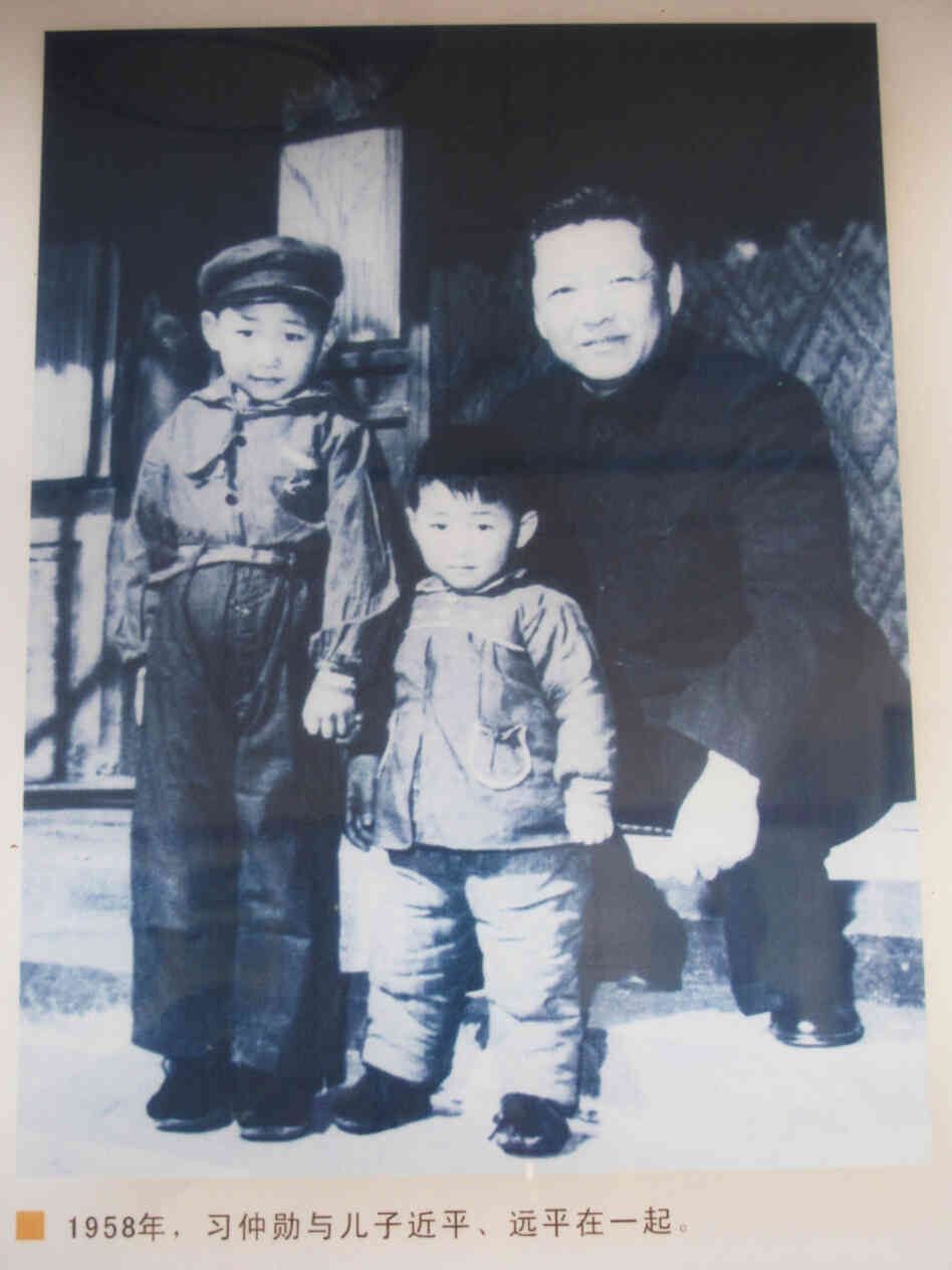 A family photograph from 1958 showing Xi Jinping (left), 5, with his brother Yuanping and father, Xi Zhongxun, is on display at a museum in Xi Zhongxun's hometown in China's Shaanxi province. A family photograph from 1958 showing Xi Jinping (left), 5, with his brother Yuanping and father, Xi Zhongxun, is on display at a museum in Xi Zhongxun's hometown in China's Shaanxi province.