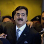 Pakistani Prime Minister Yousuf Raza Gilani is surrounded by security personnel as he arrives at Supreme Court for a hearing in Islamabad, Pakistan on Monday.