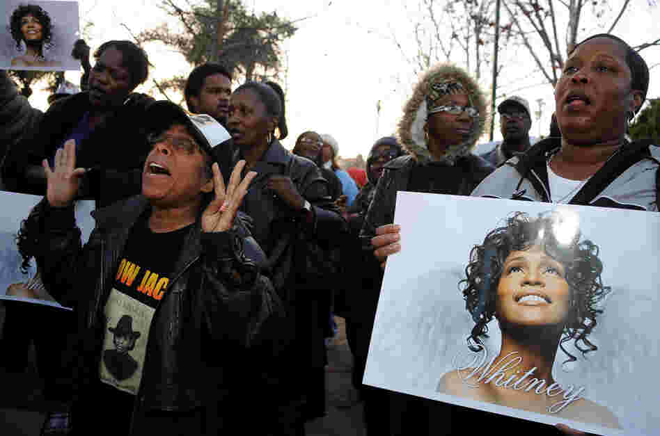 Fans attend a Whitney Houston Leimert Park Vigil on Monday in Los Angeles.