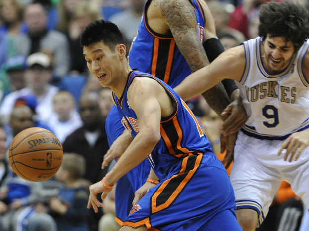 Jeremy Lin chases the loose ball in the first half of an NBA basketball game in Minneapolis. Lin is one of the few Asian-Americans in NBA history.