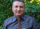 Syrian activist Dr. Kamal Labwani poses in this file photo from 2005, holding an "action file" compiled by Amnesty International about his case. Syrian activist Dr. Kamal Labwani poses in this file photo from 2005, holding an "action file" compiled by Amnesty International about his case.