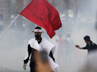 Bahraini anti-government protesters react to tear gas fired by riot police on Monday. Bahraini anti-government protesters react to tear gas fired by riot police on Monday.
