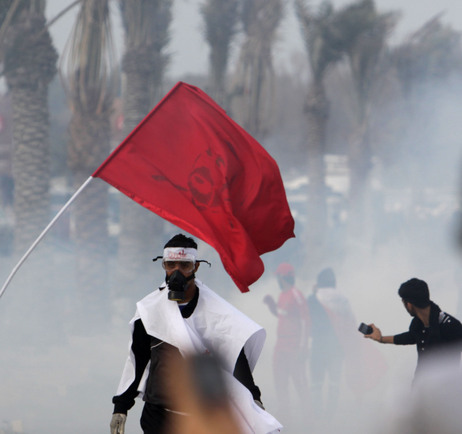 Bahraini anti-government protesters react to tear gas fired by riot police on Monday. Bahraini anti-government protesters react to tear gas fired by riot police on Monday.