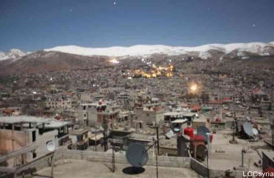 An image from the Local Coordinating Committees of Syria website shows the mountain town of Zabadani in the distance, during a barrage on Feb. 9. An image from the Local Coordinating Committees of Syria website shows the mountain town of Zabadani in the distance, during a barrage on Feb. 9.