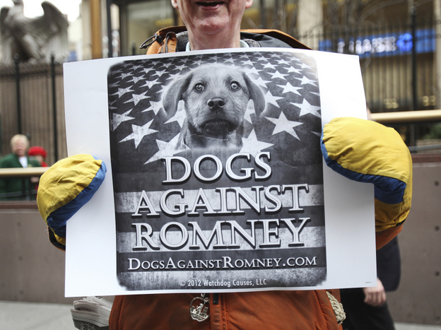 A man holds a sign during a "Dogs Against Romney" demonstration outside the 136th Westminster Kennel Club Dog Show at New York's Madison Square Garden, on Tuesday. 