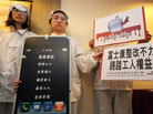 A group of protesters demonstrate outside Foxconn's annual meeting in Hong Kong last year. Working conditions at the company's plants have brought criticism on Apple. A group of protesters demonstrate outside Foxconn's annual meeting in Hong Kong last year. Working conditions at the company's plants have brought criticism on Apple.