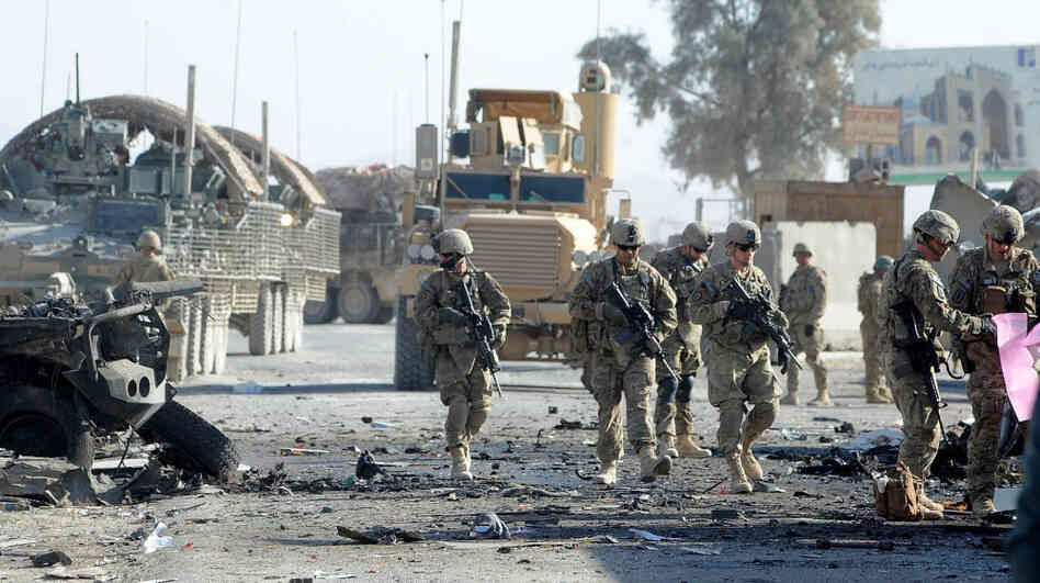 U.S. soldiers are expected to be in Afghanistan for a couple more years. But already there's a debate about future U.S. security needs worldwide. Here, soldiers examine the site of a suicide bombing in the southern Afghan city of Kandahar on Jan. 19.