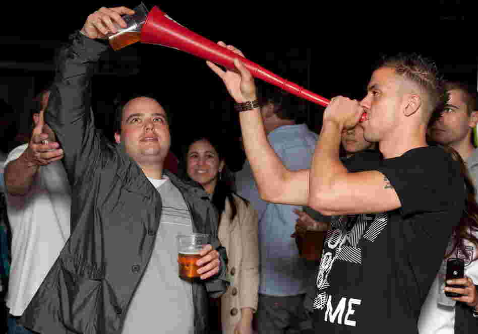 Prime Minister David Cameron calls binge drinking "one of the scandals of our society." Here, a man drinks a pint of beer through a makeshift "Vuvuzela of Ale" in London, in a file photo from 2010.