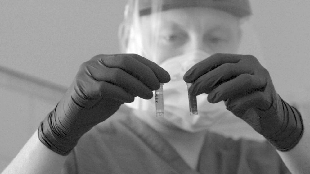 A researcher handles samples in a lab in this photo from the WHO's 2007 World Health Report.