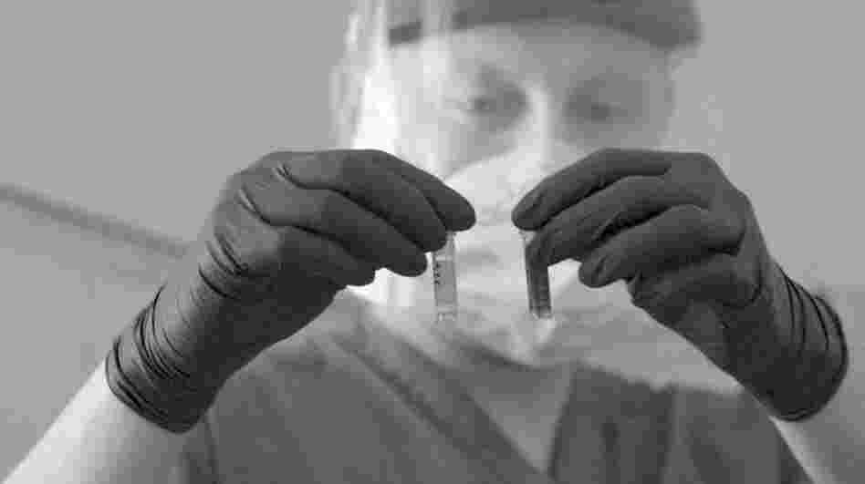 A researcher handles samples in a lab in this photo from the WHO's 2007 World Health Report.