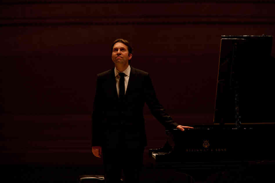 Gazing up to the balcony at Carnegie Hall, Andsnes  acknowledges the enthusiastic applause from a full house of  admirers.