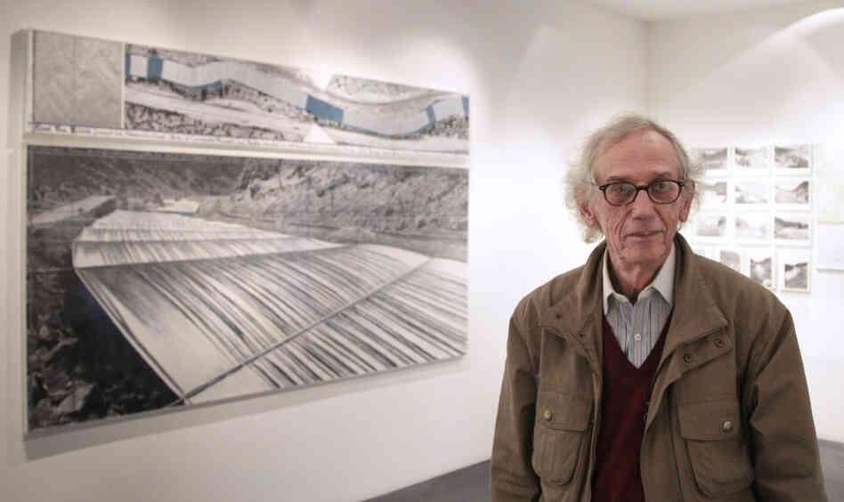 Christo stands next to one of his works at a 2010 exhibition in Paris about the Over the River project. If approved, the installation could begin in the fall.