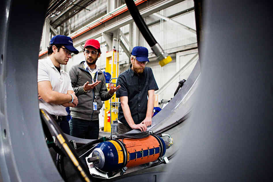 The Gamesa factory in Fairless Hills, Pa., produces nacelles for wind turbines. Nacelles house the gear box, generator, electrical transformers and wiring. From left, engineers Eric Nicosia, Amin Ahmadi and Gavin Boogs work to solve an issue with a nacelle at the factory on Feb. 10. 