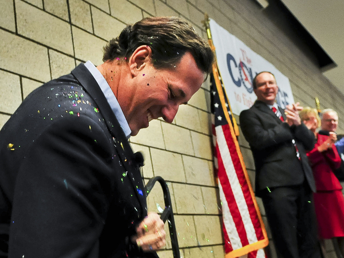 Republican presidential candidate Rick Santorum brushes off glitter after being "glitter-bombed" before a campaign rally on Feb. 7 in Blaine, Minn.