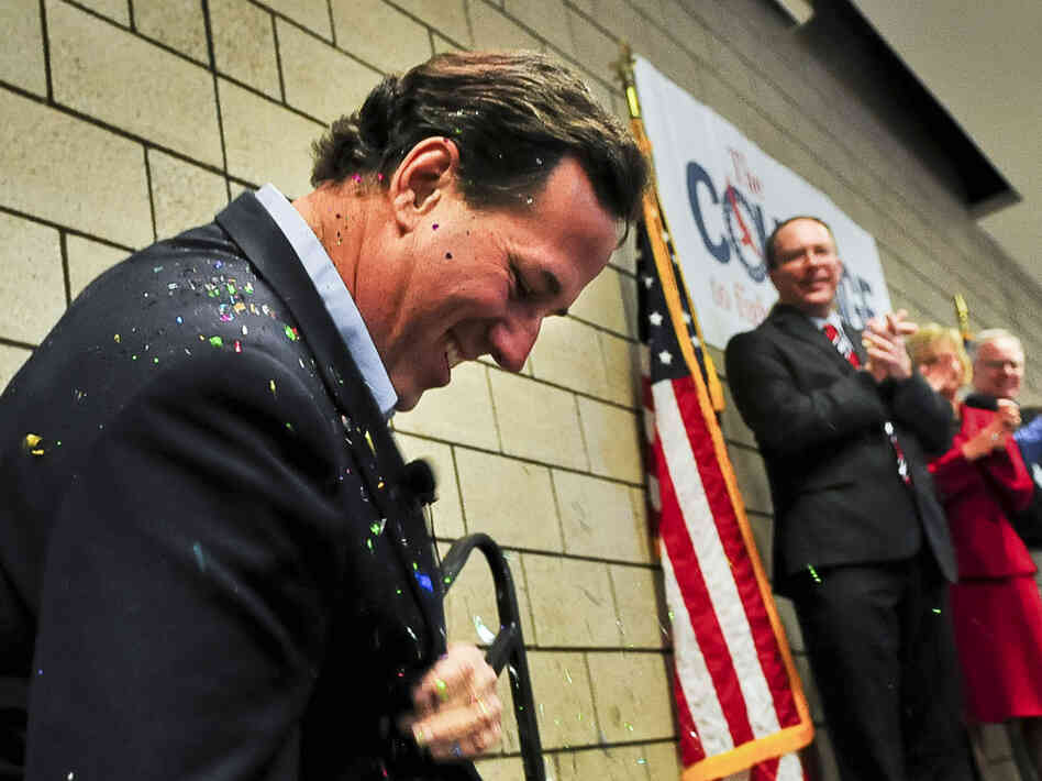 Republican presidential candidate Rick Santorum brushes off glitter after being "glitter-bombed" before a campaign rally on Feb. 7 in Blaine, Minn.