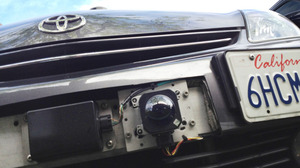 A car camera attached to the front bumper of Google's driverless car.