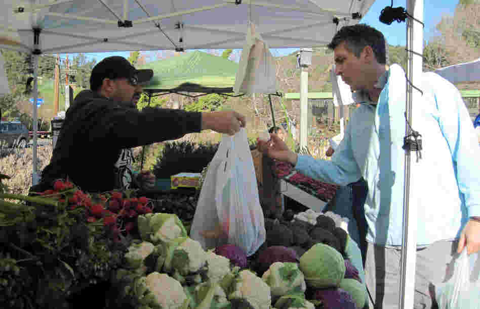 Life is a "collection of extraordinarily ordinary moments," Payne says. "We just need to pay attention to them all." Above, Payne stops at a farmers market near his home in the Santa Monica Mountains.
