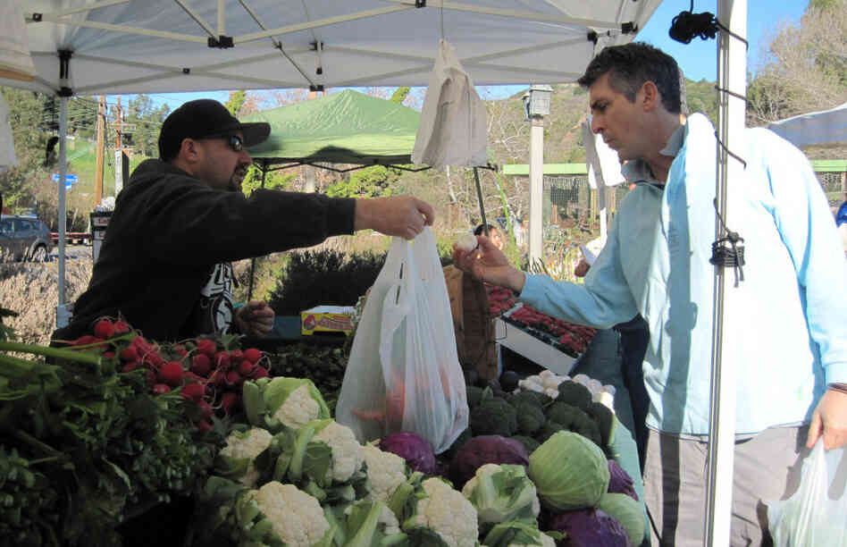 Life is a "collection of extraordinarily ordinary moments," Payne says. "We just need to pay attention to them all." Above, Payne stops at a farmers market near his home in the Santa Monica Mountains.