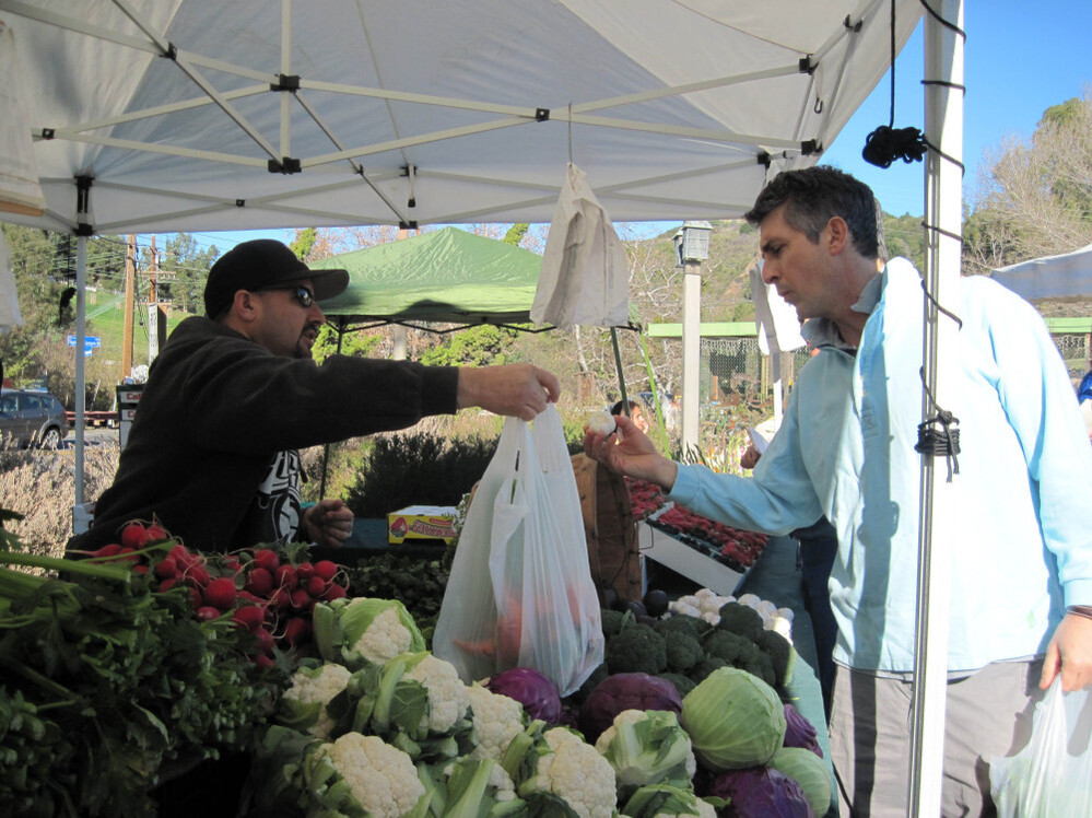 Life is a "collection of extraordinarily ordinary moments," Payne says. "We just need to pay attention to them all." Above, Payne stops at a farmers market near his home in the Santa Monica Mountains.