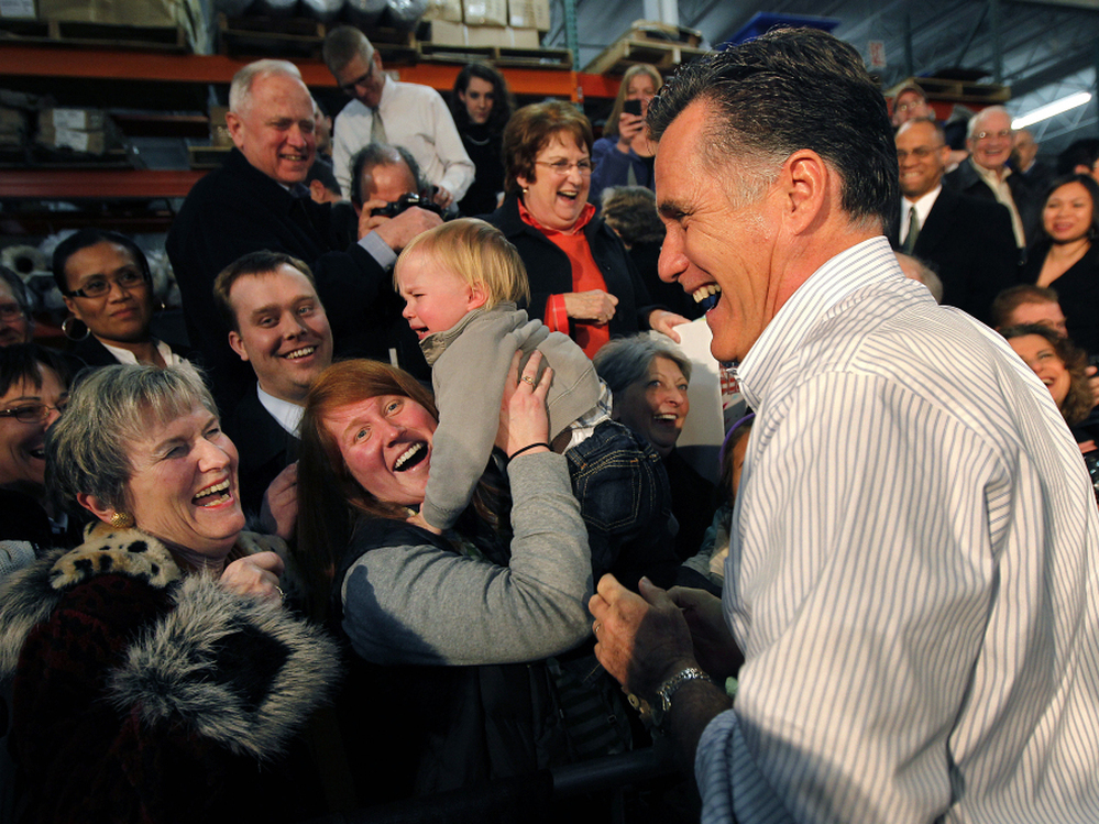 Mitt Romney laughs with supporters at a rally in Kentwood, MI, Wednesday, Feb. 15, 2012.  