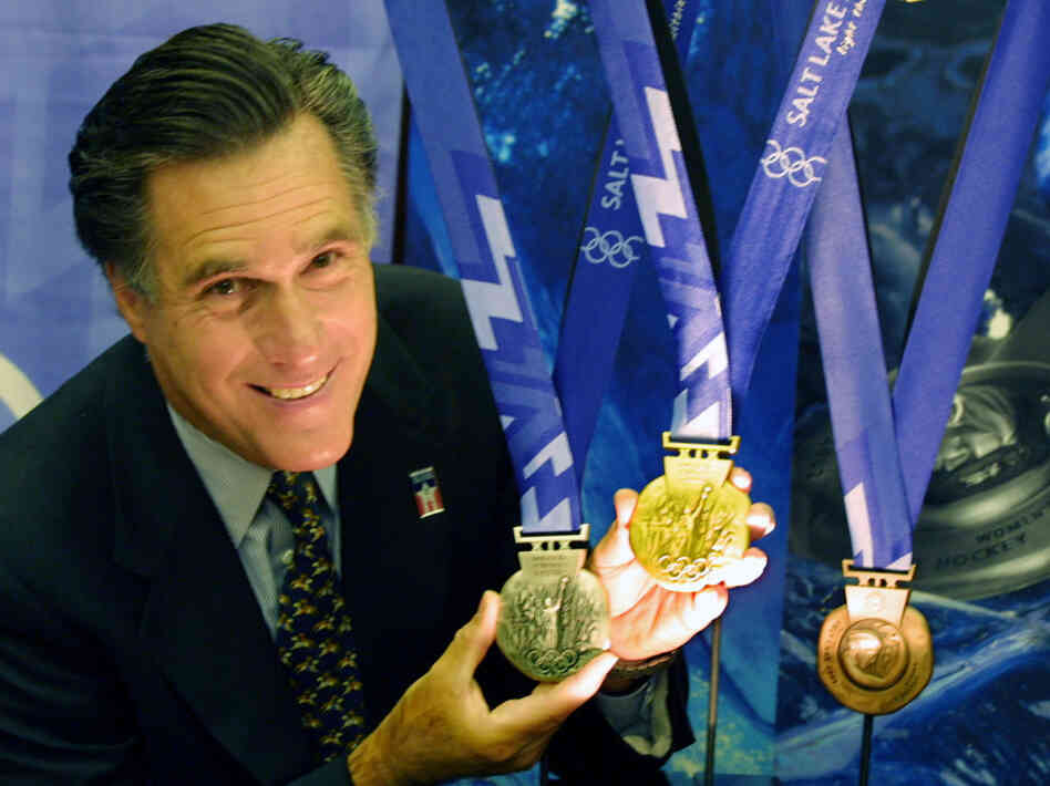 Mitt Romney, then-president of the Salt Lake Organizing Committee, displays medals that would be awarded at the 2002 Winter Olympics in October 2001. 
